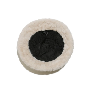 Detailed interior of winter faux fur bucket hat featuring black quilted lining and adjustment strap