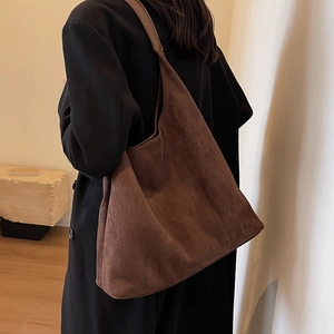 Brown frosted large capacity tote bag with suede texture shown on shoulder for daily use