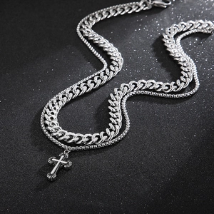 Double-layered stainless steel necklace featuring a cross pendant and Cuban link chains