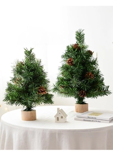 Close-up of small artificial Christmas trees with natural pine cones and wooden bases