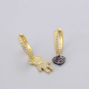 Detail of gold-plated hoop earrings featuring micro-paved zircon bear and heart charms
