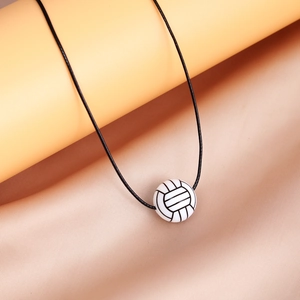 Macro shot of volleyball sports pendant with realistic texture and black cord necklace