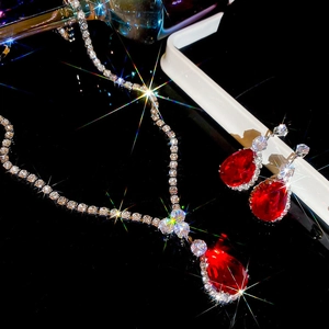 Exquisite silver necklace and earrings set with red pear-cut stones and sparkling crystals