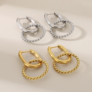 Detailed close-up of gold and silver twisted geometric stainless steel earrings
