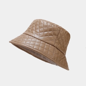 Close-up of quilted beige PU leather bucket hat with detailed diamond stitching pattern