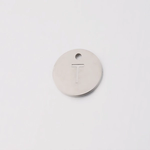 Detailed view of silver 12mm stainless steel round pendant with letter T engraving