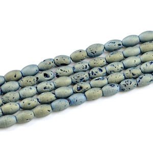Macro detail of oval blue druzy agate beads showing natural sparkling crystal textures