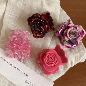 Floral acetate rose hair claws in pink marble, tortoiseshell, and colorful patterns