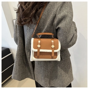 Close-up of retro color-block crossbody bag with faux fur trim and gold hardware