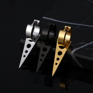Macro view of geometric triangle drop earrings in silver, black and gold steel