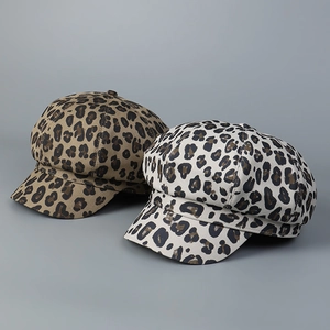 Detail view of leopard print baker boy caps in brown and beige canvas fabrics