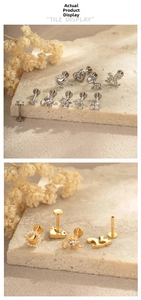 Makroaufnahme von Titan-Labret-Steckern in Herz-, Pferd- und Blumenform in Gold und Silber