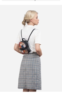 Fashionable women's plaid backpack with leather and fabric patchwork on female model