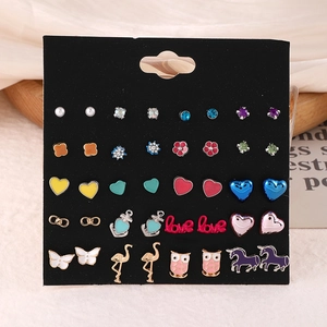 Close-up of 20 pairs of alloy stud earrings featuring pearl, owl and unicorn motifs
