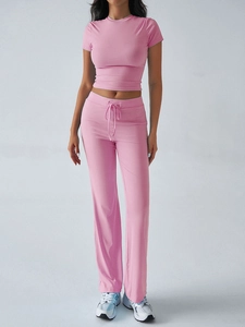 Close-up of pink casual sport set featuring crew neck t-shirt and drawstring trousers
