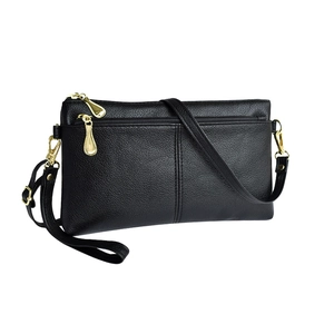 Elegant black lychee leather crossbody bag with dual golden zippers on white background