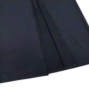 Detailed close-up of the elegant side slit design and stitching on a black maxi dress