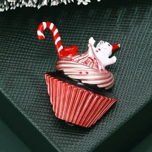 Christmas cupcake brooch with snowman and candy cane detail on a metal enamel pin