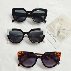 Three pairs of vintage cat eye sunglasses in black, white, and tortoiseshell patterns