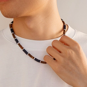 Men's surf style beaded necklace with brown coconut husks and black cylinder beads