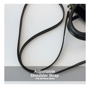 Detail view of the adjustable black leather strap with precise edge stitching and quality finish