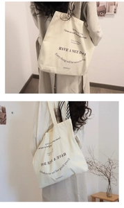 Detail showing beige canvas tote bag with silk-screened motivational typography quotes