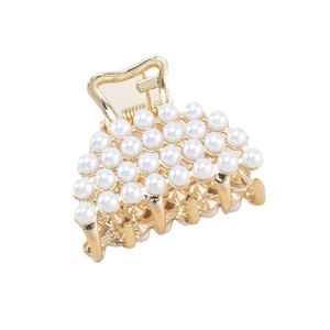 Elegant gold metal shark hair claw clip with multiple white pearls on white background