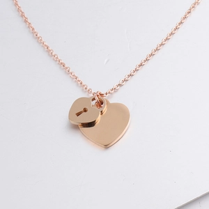 Close-up of rose gold double heart pendant necklace with a lock hole detail