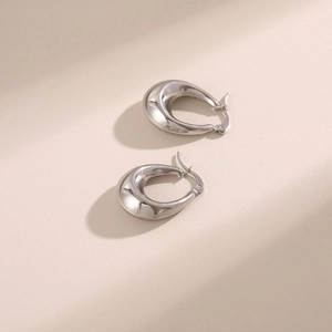 Minimalist silver thick hoop earrings with smooth metallic finish and elegant teardrop shape