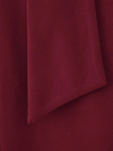 Detailed macro view of the premium burgundy wool fabric texture and soft fiber weave