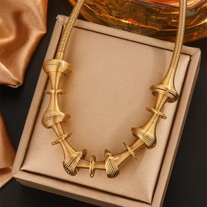 Detailed view of 18K gold-plated spring coil necklace with industrial spiral pendants