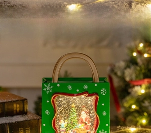 Christmas lantern featuring Santa Claus scene with snow effect and warm LED lighting
