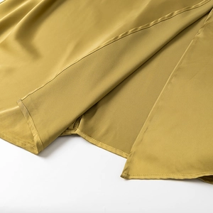 Elegant mustard yellow satin slip dress featuring a high side slit and silky texture
