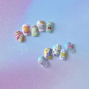 Macro detail of 3D embossed nail art stickers featuring cute rabbits and bows in pastel colors