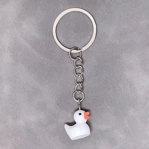 Detailed close-up of a 3D resin duck charm attached to a silver metal keychain ring
