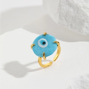 Detail of light blue Evil Eye glass ring on gold band with adjustable open design