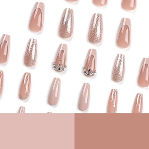 French glitter press-on nails in long coffin shape with pink gradient and rhinestones