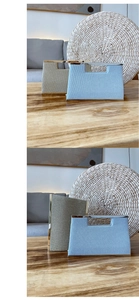 Detail view of woven textured evening clutch bags in light blue and silver metallic finishes