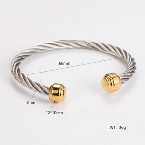 Macro shot of two-tone cable bangle showing dimensions 68mm inner diameter and 6mm thickness