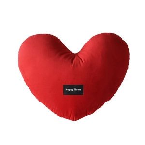 Red heart-shaped velvet pillow with Happy Home label on a clean white background