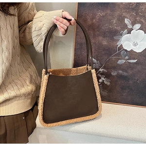 Detail of vintage brown tote bag with fuzzy faux fur trim and textured leather handles