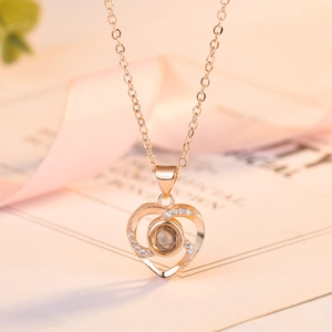 Rose gold heart projection necklace with I Love You in 100 languages for women