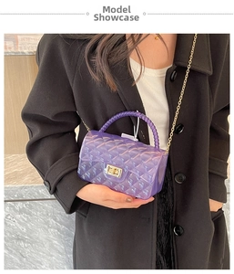 Detail of purple transparent jelly bag with quilted pattern, bead handle and gold chain