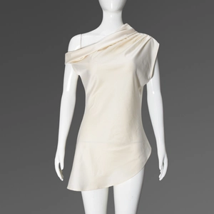 Detailed view of cream satin fabric on an asymmetrical one-shoulder sleeveless top