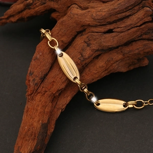 Detailed view of golden pig nose chain links on a natural wood texture background
