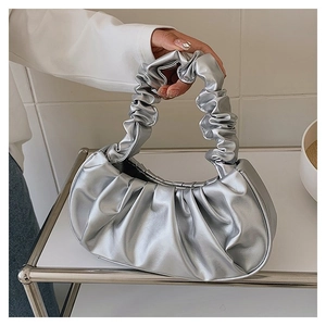 Detail view of the silver pleated cloud bag with metallic finish and integrated handle