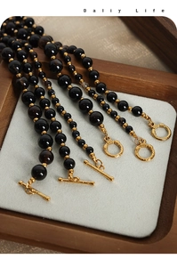 Detailed view of natural agate beads with gold OT buckle on a minimalist necklace