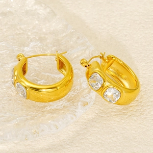 Polished 18K gold-plated chunky hoop earrings with square zircon stones on water-textured glass