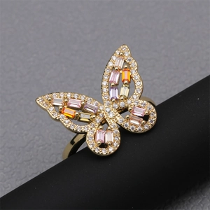 Gold butterfly ring with colorful cubic zirconia stones and pavé setting on a black stand