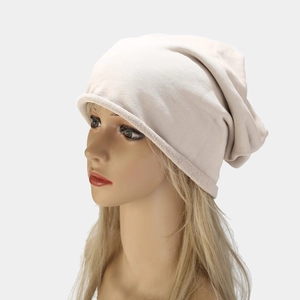 Beanie hat in beige knit with a slouchy fit and soft texture for winter fashion